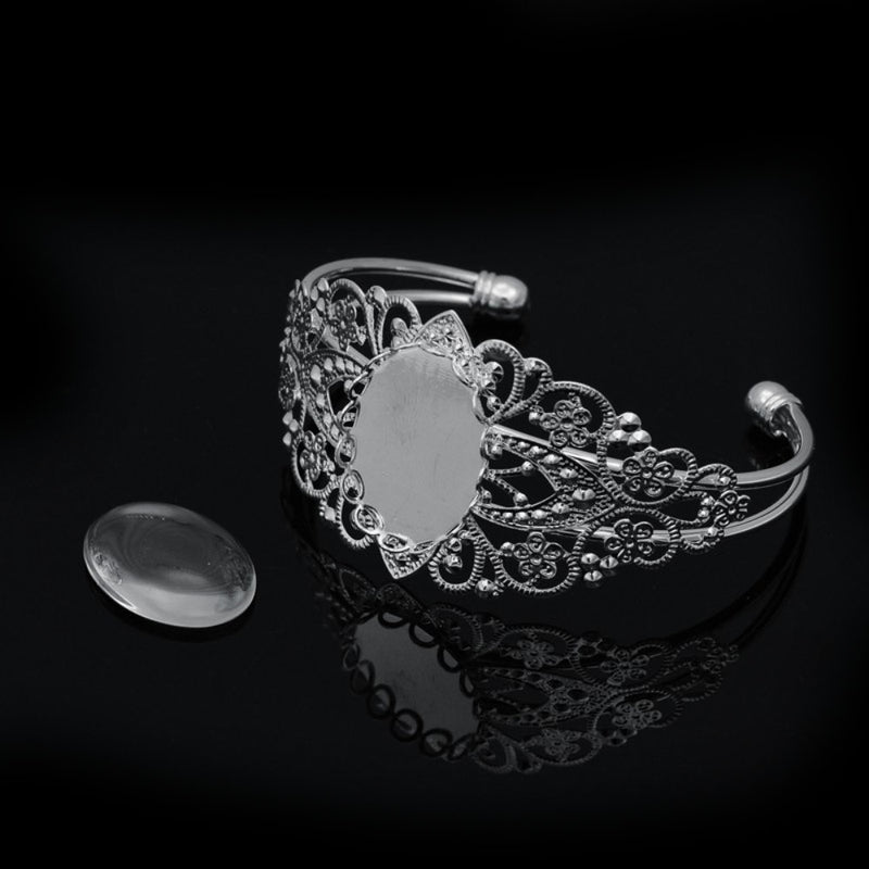 Load image into Gallery viewer, Filigree Brass Cuff Bangle with Oval Transparent Glass Cabochon 5.7cm x 3.6cm Silver - Affordable Jewellery Supplies

